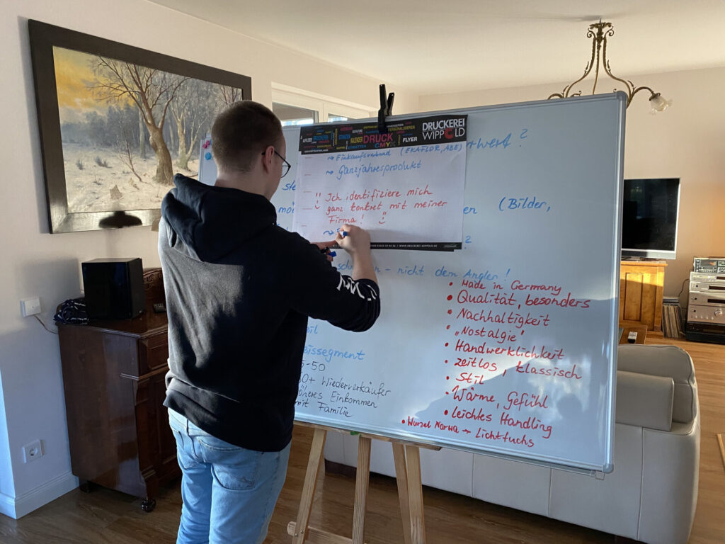 a man writing on a whiteboard